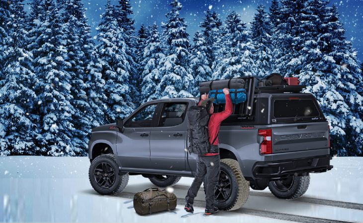 action shot of truck in a snowy forest with focus on RSI smartcap evo sport truck bed cover