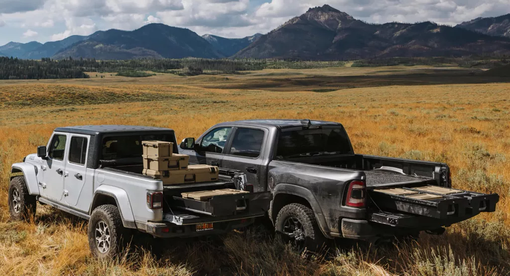 Two trucks equipped with Decked truck bed drawer systems in the middle of a field