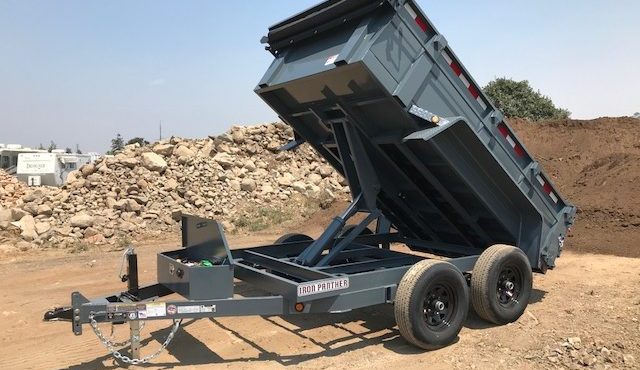 This is a dump trailer with a scissor lift available at Truck Tops USA in Santa Rosa.