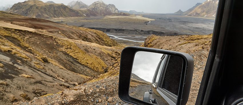 View from inside black Jeep looking out onto a mountainy landscape, off-road, overland concept