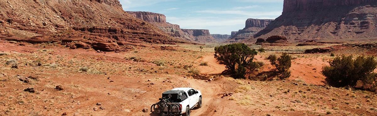 suv with bikes driving through canyon