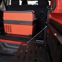 Rough Country Rechargeable Electric Cooler loaded into the back of a Red Jeep Wrangler