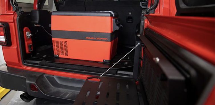 Rough Country Rechargeable Electric Cooler loaded into the back of a Red Jeep Wrangler