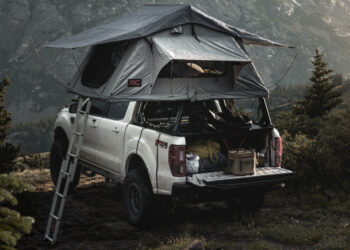 Rough Country Rooftop tent installed on a white mid size pickup truck parked on a mountainside look out