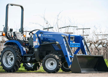 Solectrac e25 electric tractor parked in front of a Vineyard in Sonoma County