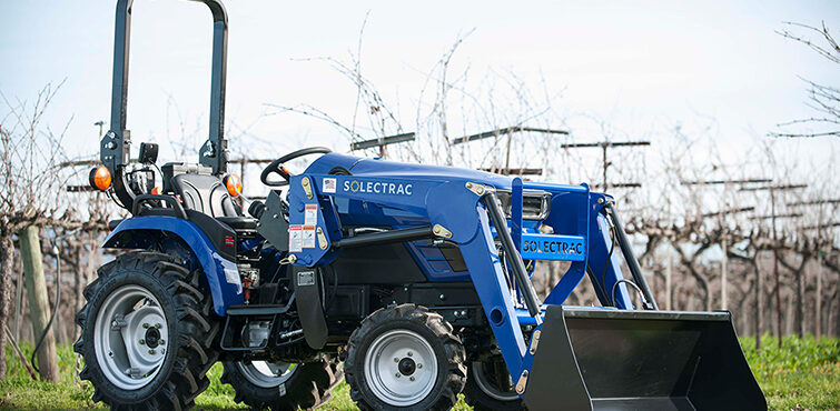 Solectrac e25 electric tractor parked in front of a Vineyard in Sonoma County